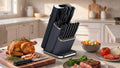 Ninja StaySharp 13-Piece Knife Block in Black on a kitchen counter with a carved turkey