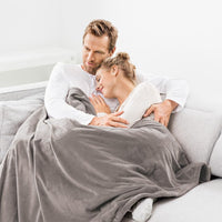 Beurer HD 150 XXL Heated Overblanket 200x150cm Taupe, couple relaxing under blanket on sofa
