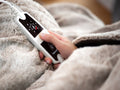 Beurer HD 150 XXL digital controller detail on taupe blanket