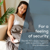 Beurer HD 75 Heated Overblanket Taupe, lifestyle shot of woman using blanket on sofa