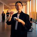 Sennheiser ACCENTUM Clip Open-Ear Earphones Cream — lifestyle, held in office hallway