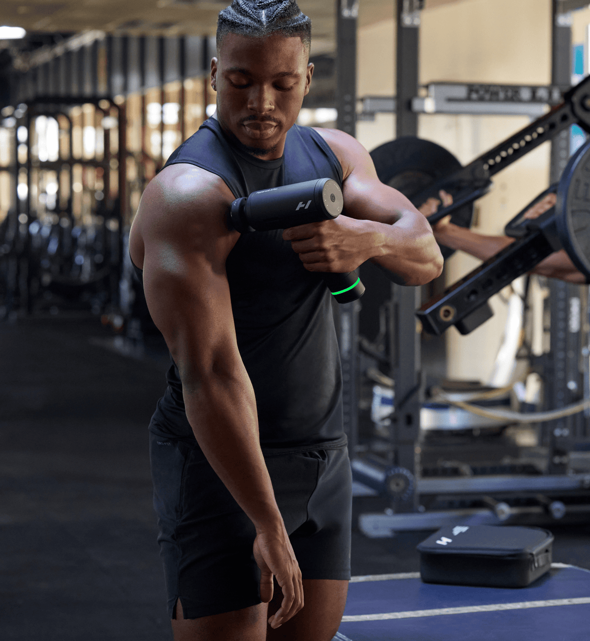 Hyperice Hypervolt 3 Pro Percussion Massage Gun - Black - in use on the upper arm