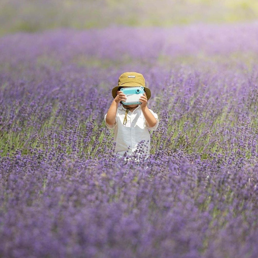 myFirst Camera Insta 2 Kids Instant Print Camera - Blue - child with the camera in a lavender field