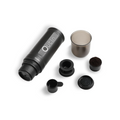Outin Nano portable espresso machine in Space Grey with ground coffee, coffee capsules and a glass of espresso