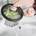 Stellar Stay Cool 4 Piece Draining Saucepan Set SLB2 lifestyle draining-lid action shot
