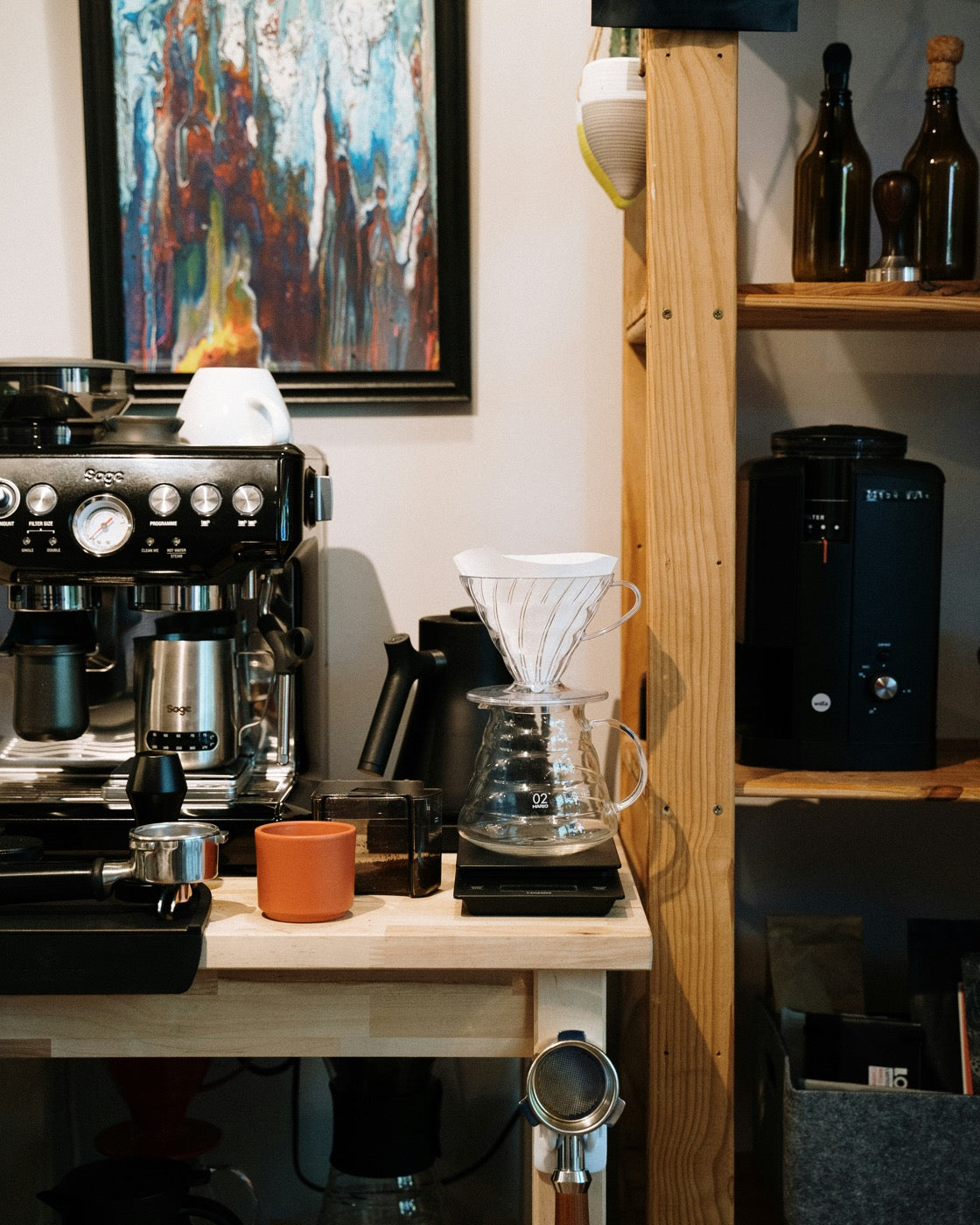 Espresso machine, grinder and pour-over on a home coffee bar