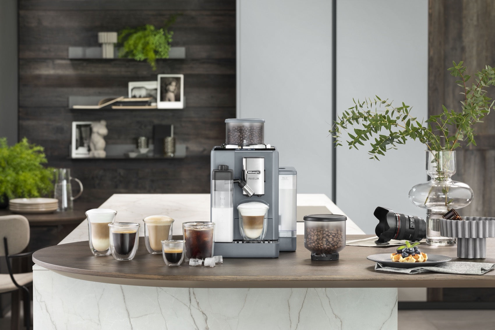 De'Longhi coffee machine on a kitchen island with lattes, espresso and iced coffee